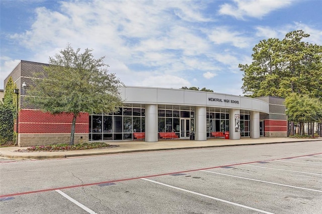 view of property featuring uncovered parking