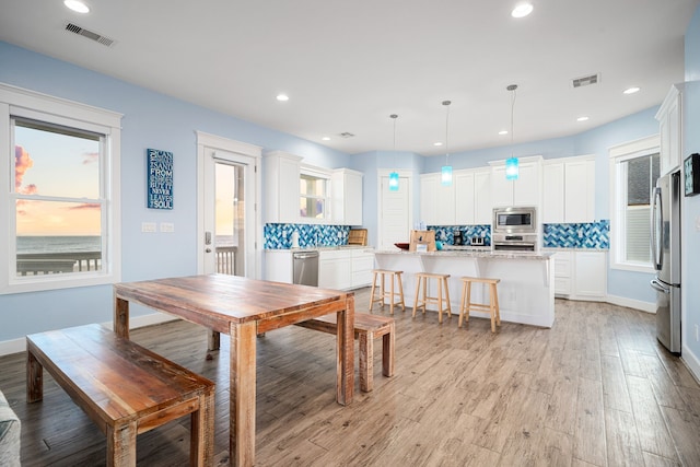 dining area featuring light wood-style floors, visible vents, and recessed lighting