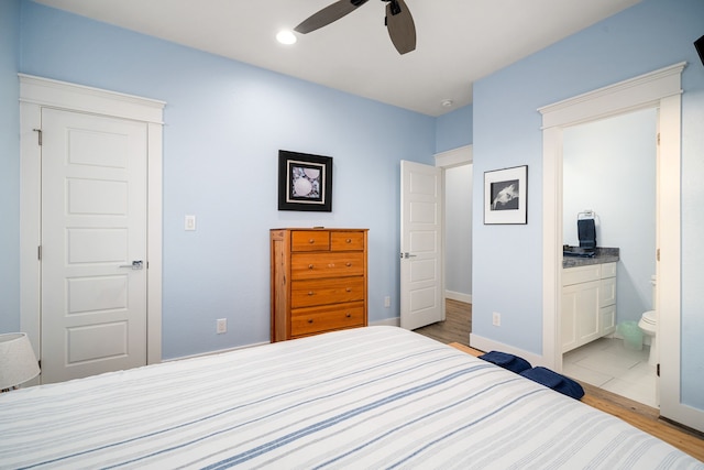 bedroom featuring ceiling fan, connected bathroom, light wood-style flooring, recessed lighting, and baseboards