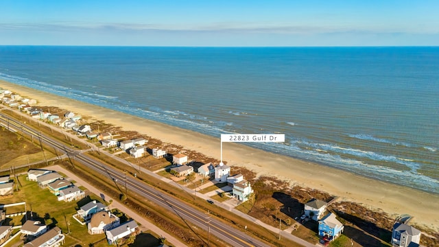 bird's eye view with a water view, a residential view, and a view of the beach