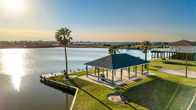 exterior space featuring a water view, a yard, and boat lift