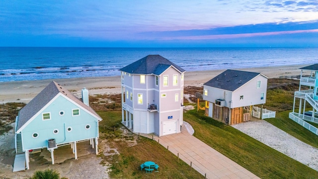 drone / aerial view with a water view and a beach view