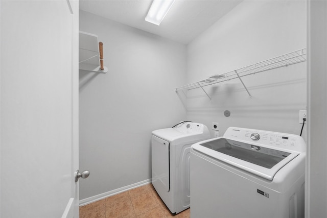 24510 Foxberry Glen Ln, Katy, TX 77494 - laundry area featuring light tile patterned floors, baseboards, separate washer and dryer, and laundry area