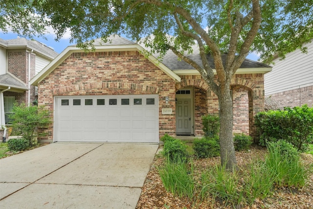 24510 Foxberry Glen Ln, Katy, TX 77494 - view of front of property featuring brick siding, roof with shingles, driveway, and a garage