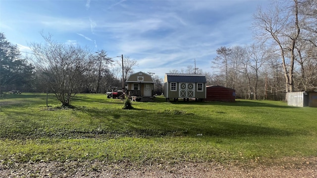 view of yard featuring an outbuilding and a storage shed