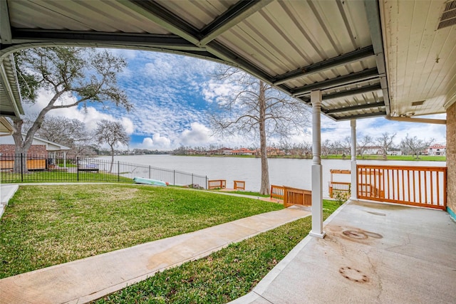 view of patio / terrace with a water view and fence