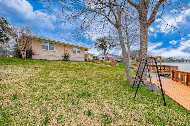 view of yard featuring a deck with water view