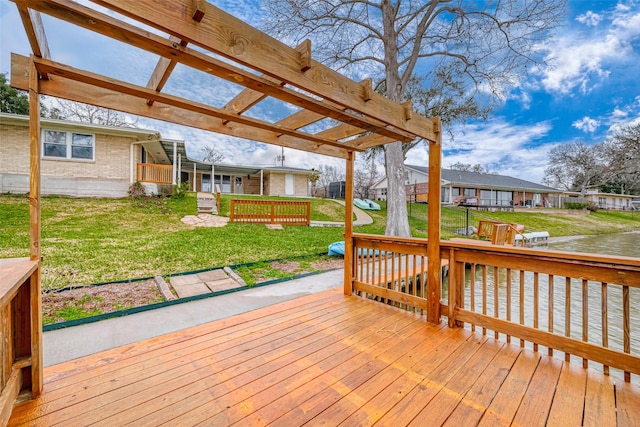 wooden deck featuring a water view, a lawn, and a pergola