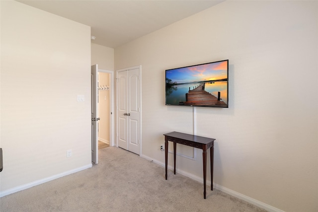 hallway with baseboards and carpet