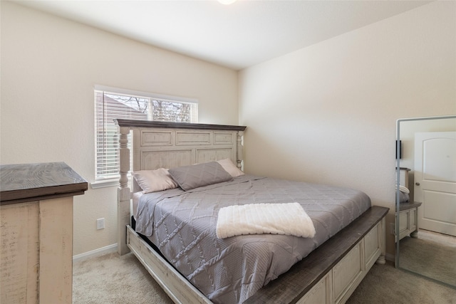 bedroom featuring baseboards and light carpet