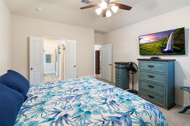 bedroom featuring a ceiling fan, visible vents, baseboards, vaulted ceiling, and light colored carpet