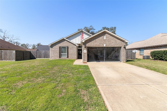 view of front of property with a front lawn, driveway, cooling unit, an attached garage, and brick siding