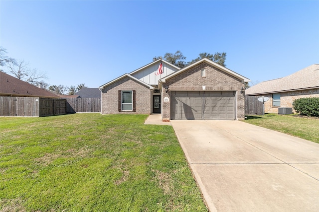 view of front of property with board and batten siding, an attached garage, fence, a front yard, and driveway