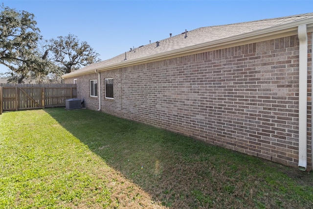 view of yard with cooling unit and fence