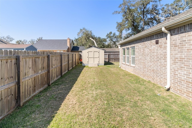 view of yard featuring an outdoor structure, a storage shed, and a fenced backyard