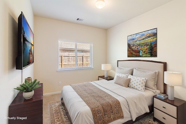 bedroom with carpet flooring, baseboards, and visible vents