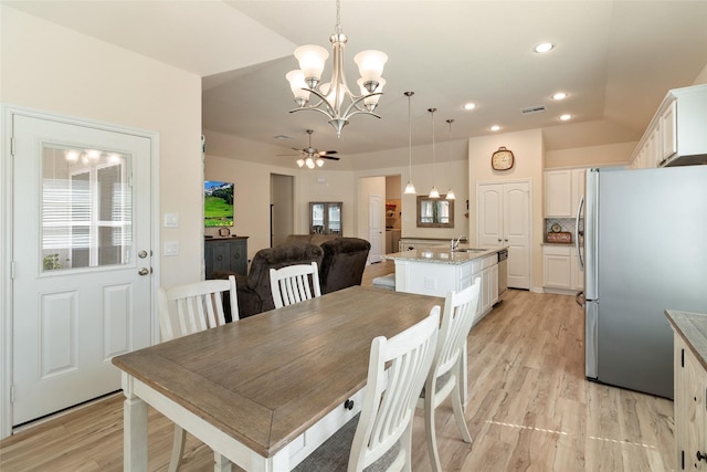 dining room featuring vaulted ceiling, recessed lighting, visible vents, and light wood-type flooring