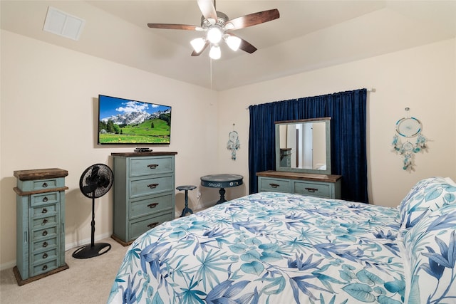 bedroom with ceiling fan, light colored carpet, visible vents, and baseboards