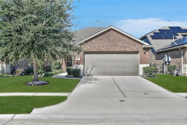 view of front of house with driveway, brick siding, and a front yard