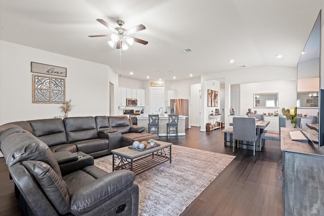 living area with visible vents, a ceiling fan, lofted ceiling, dark wood-type flooring, and recessed lighting