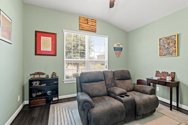 sitting room with a ceiling fan, vaulted ceiling, dark wood finished floors, and baseboards