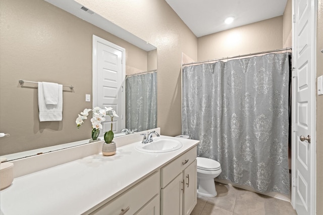 bathroom with curtained shower, visible vents, toilet, vanity, and tile patterned flooring