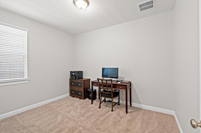 carpeted office space with visible vents and baseboards