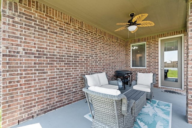 view of patio with a grill and a ceiling fan