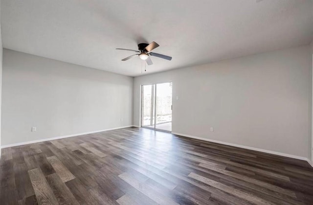 unfurnished room with dark wood finished floors, baseboards, and ceiling fan