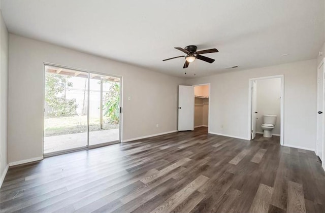 interior space featuring dark wood-type flooring, ceiling fan, and baseboards