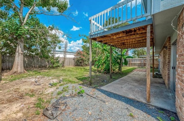 view of yard featuring a fenced backyard, a deck, and a patio