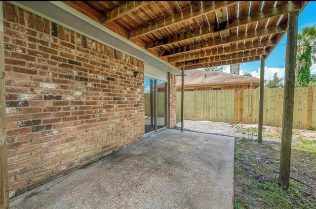 view of patio featuring fence