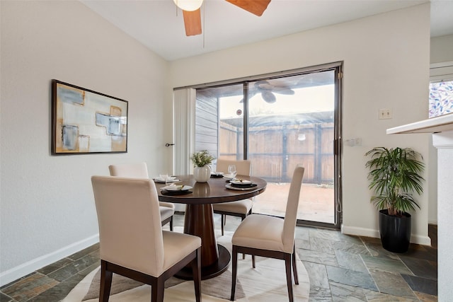 dining room with stone tile flooring, baseboards, and ceiling fan