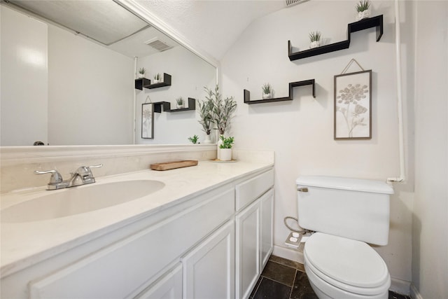 half bath with vanity, toilet, baseboards, and visible vents