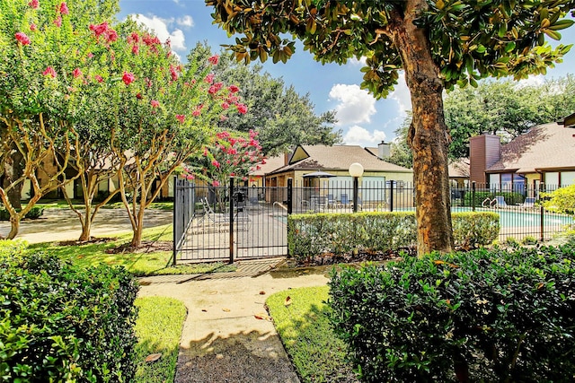 exterior space with a fenced in pool and fence