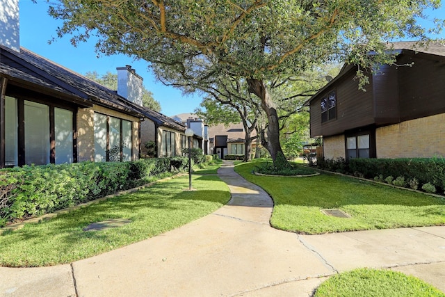 view of home's community with a yard