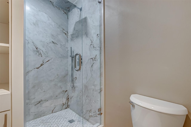 full bathroom featuring a marble finish shower and toilet