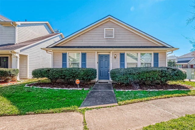 bungalow-style home featuring a front yard