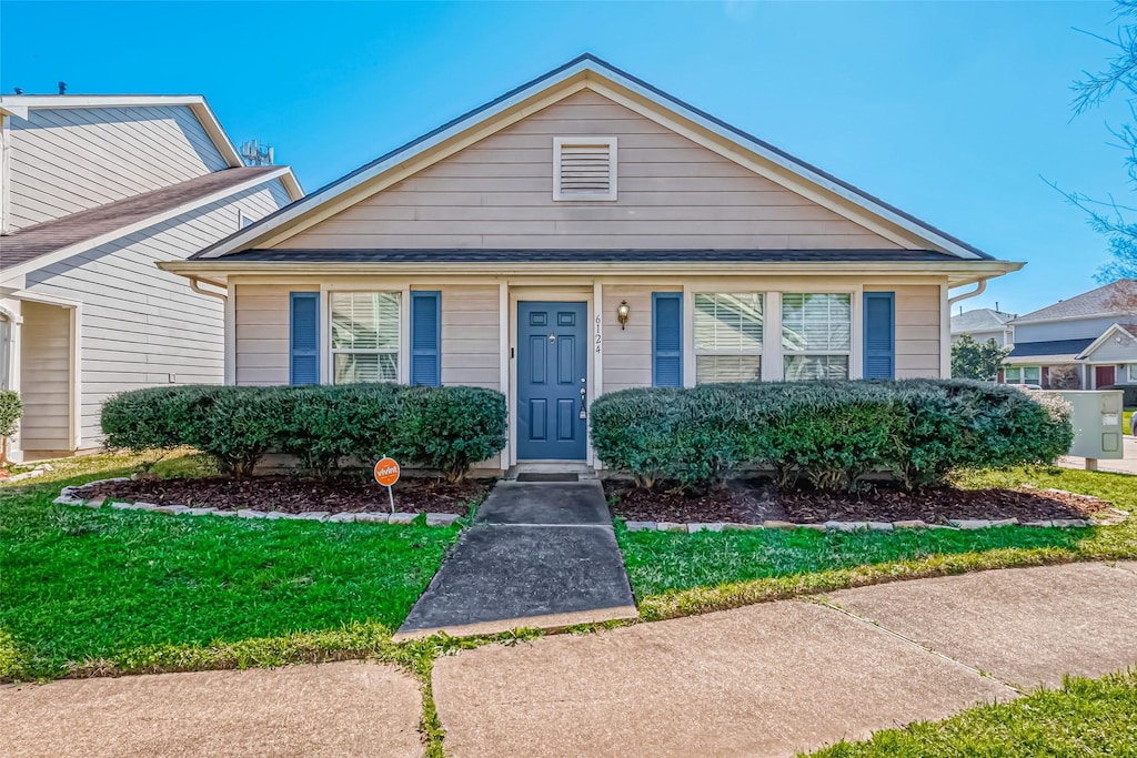 bungalow with a front yard