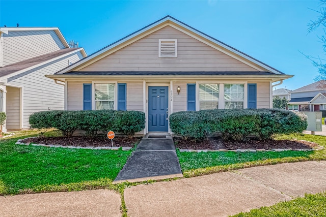 bungalow with a front yard