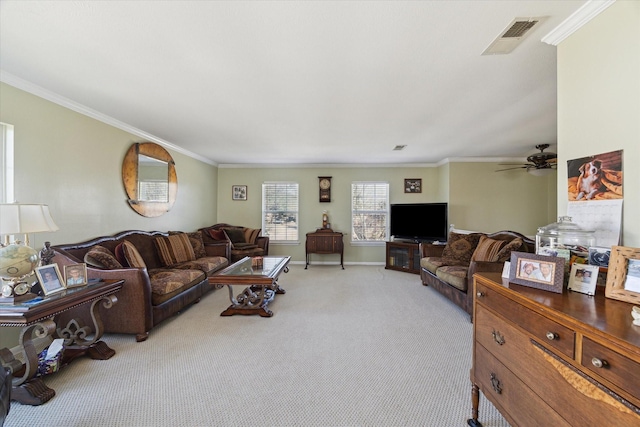 living room featuring light colored carpet, a ceiling fan, baseboards, visible vents, and crown molding