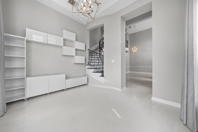 entryway featuring baseboards, stairs, visible vents, and an inviting chandelier