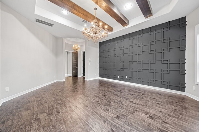 interior space with dark wood-style floors, baseboards, visible vents, and a notable chandelier