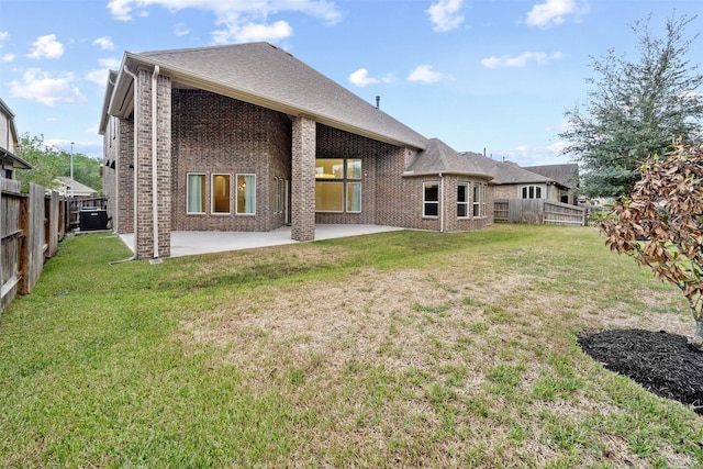 rear view of property featuring a patio area, a fenced backyard, a lawn, and brick siding