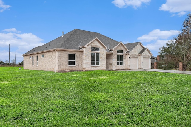 view of front of house with a garage, a shingled roof, brick siding, driveway, and a front yard