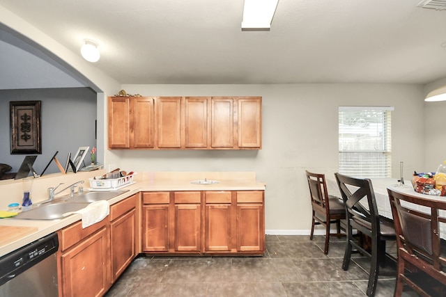 kitchen with light countertops, dishwasher, visible vents, and a sink