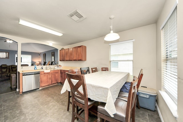 dining space with visible vents, arched walkways, and a wealth of natural light