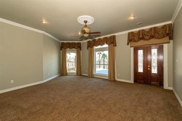 foyer featuring carpet, baseboards, ornamental molding, and ceiling fan