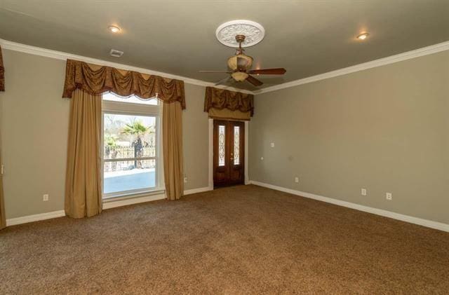 interior space with ornamental molding, carpet, and baseboards