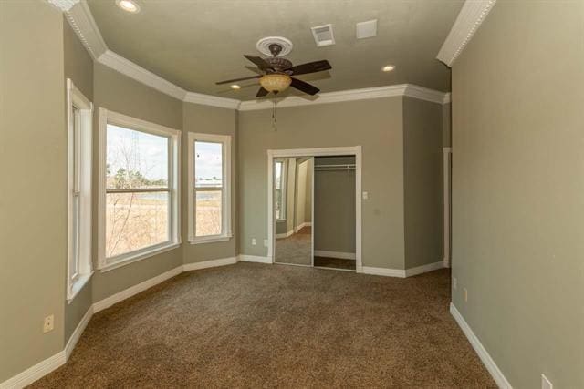 unfurnished bedroom with recessed lighting, baseboards, dark carpet, and ornamental molding